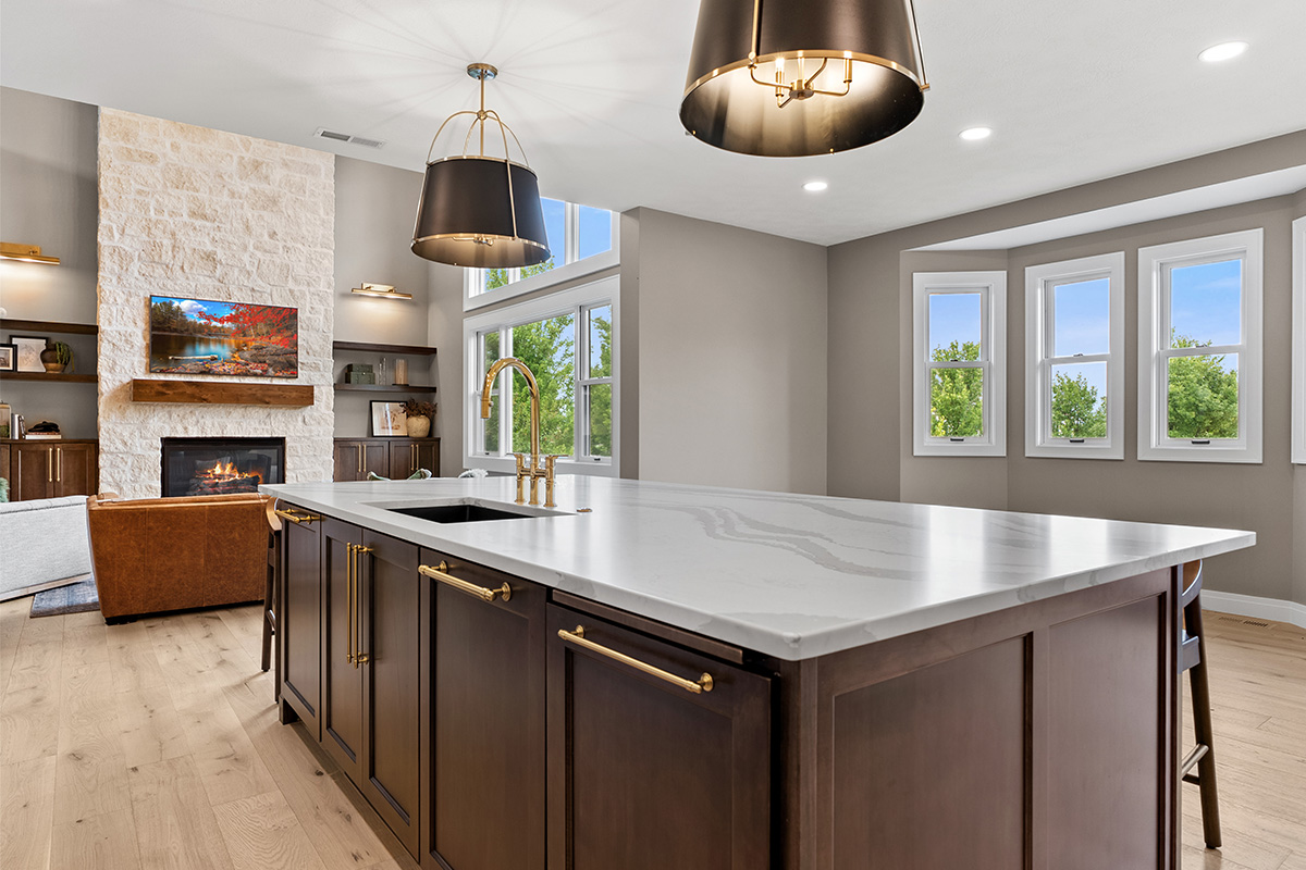 White and dark stained kitchen cabinets with white counter.