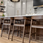 White and dark stained kitchen cabinets with white counter.