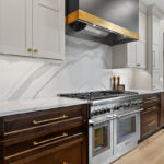 White and dark stained kitchen cabinets with white counter.