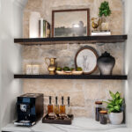 White kitchen cabinets with dark stained floating shelves