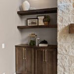 Dark stained bar cabinet and floating shelves