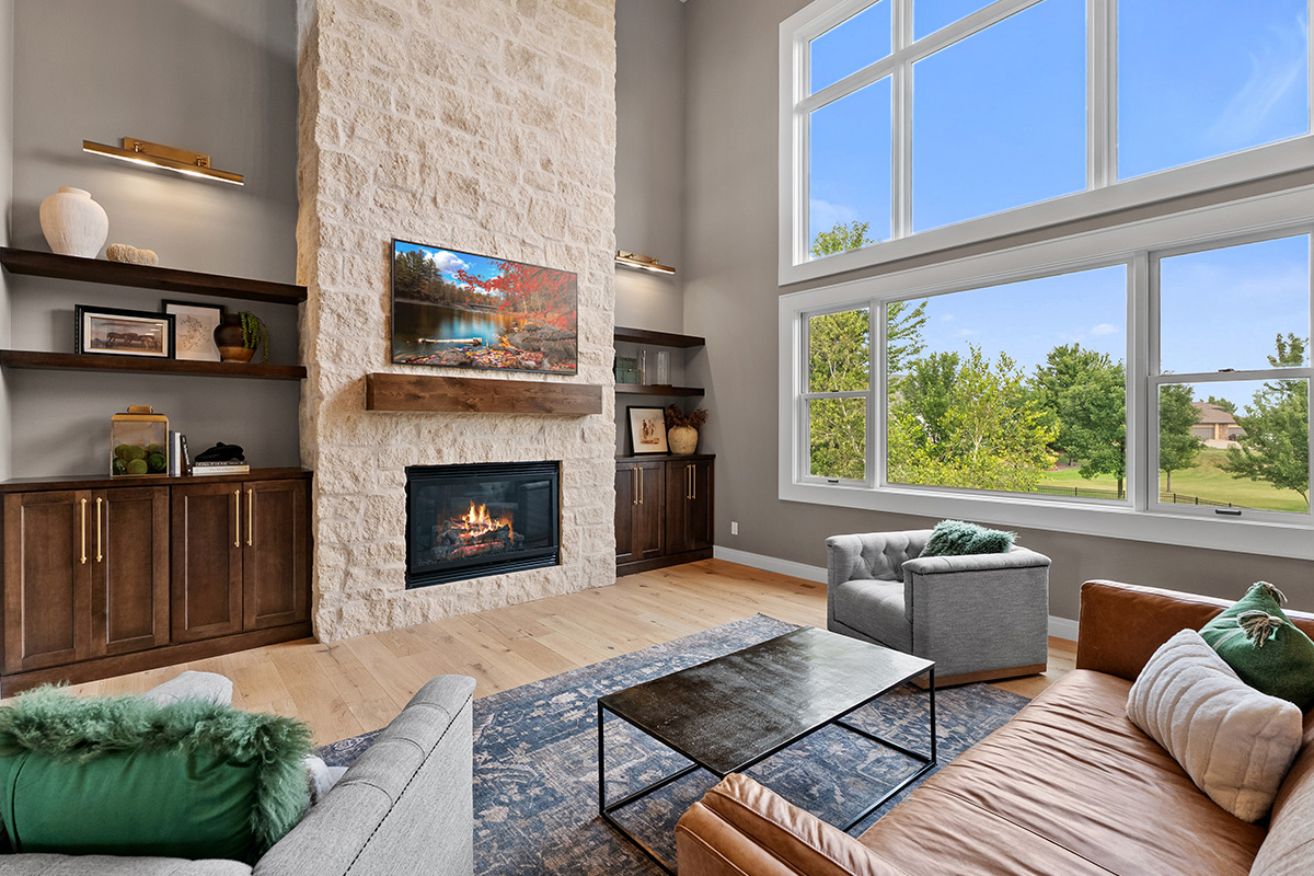 Fireplace with dark stained cabinets on each side.