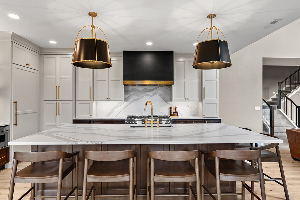 White and dark stained kitchen cabinets with white counter.