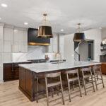 White and dark stained kitchen cabinets with white counter.