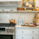 White kitchen cabinets with stainless steel stove.