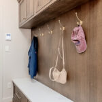 Brown stained mudroom with locker and bench seating