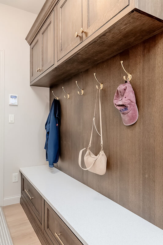 Brown stained mudroom with locker and bench seating