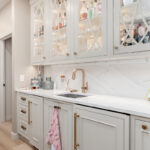 Beige painted bar cabinets with mullion doors