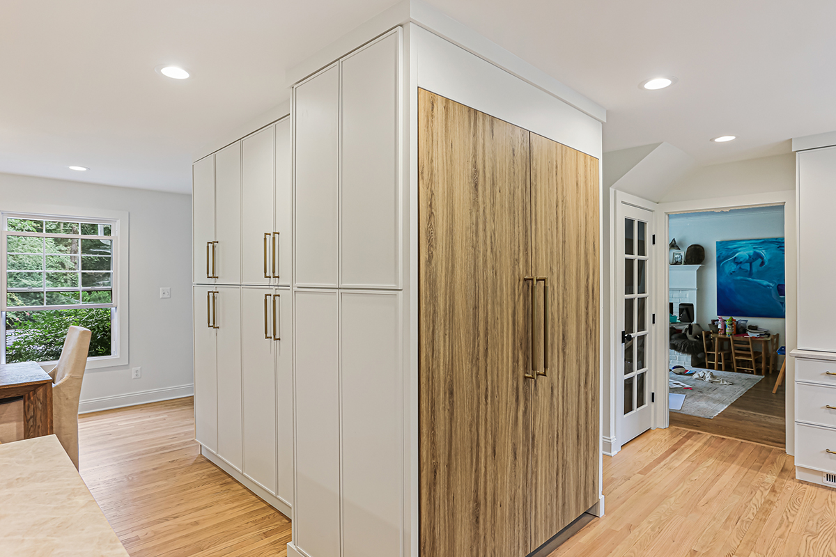 Ginger surface fridge panels and white painted kitchen cabinets.